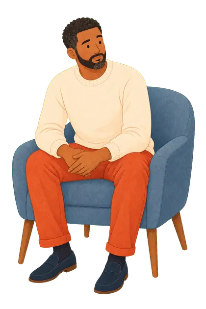 An adult man seated thoughtfully in a calm space